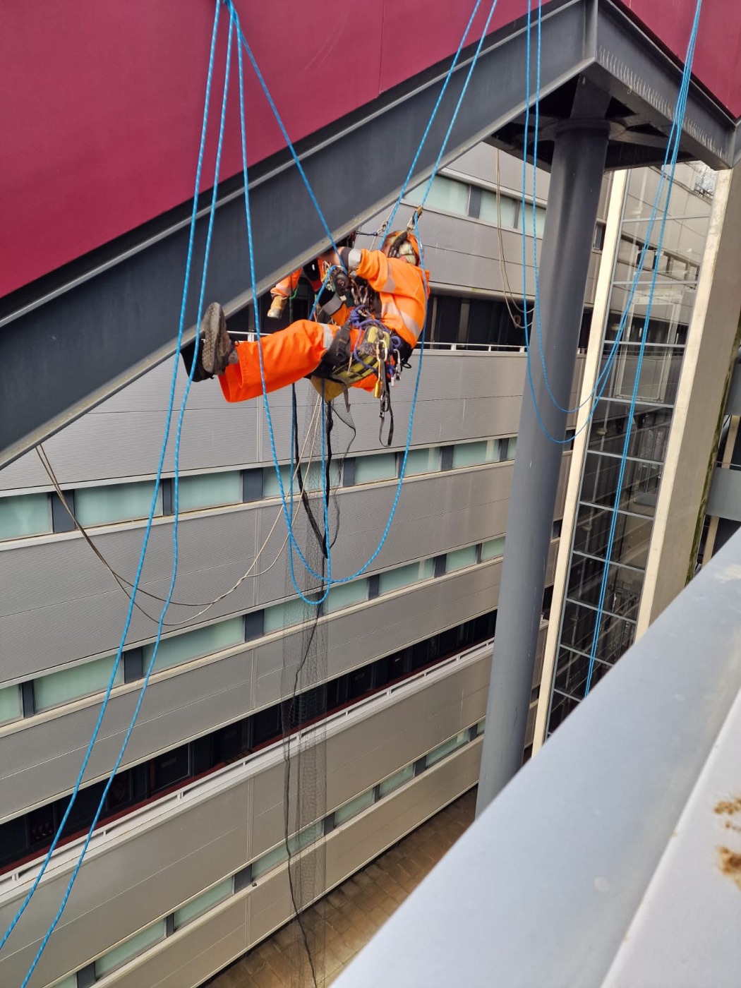 Technician on rope at a building façade